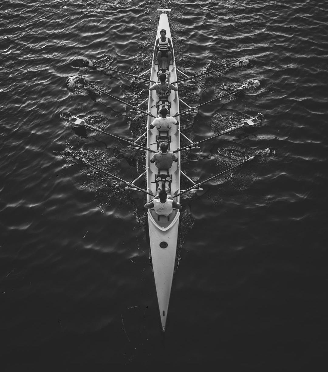 people riding boat on body of water people riding boat on body of water