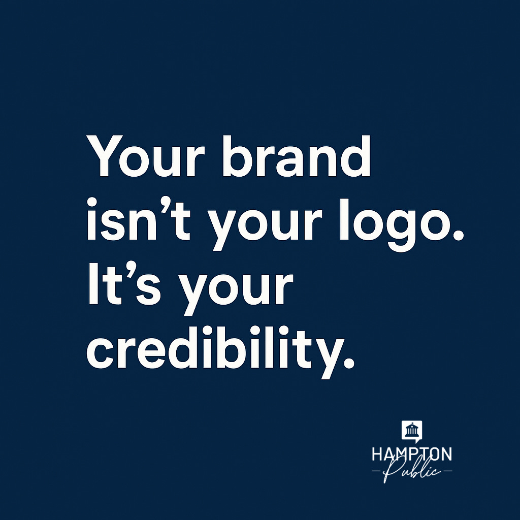 Dark blue graphic with bold white text that reads: “Your brand isn’t your logo. It’s your credibility.” In the bottom right corner is the Hampton Public logo, featuring a white icon of a classical building above the words “HAMPTON Public.”