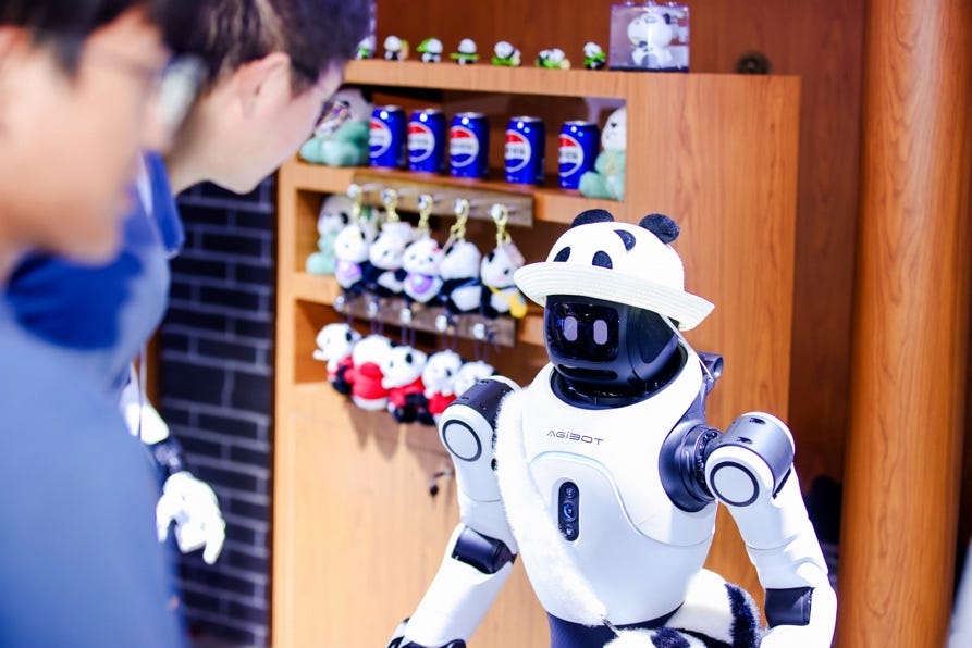 An AgiBot Lingxi X2 wearing a panda hat faces visitors beside shelves of merchandise.