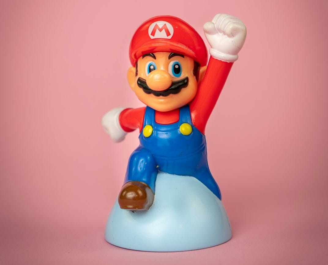 a toy figure of mario on top of a blue object