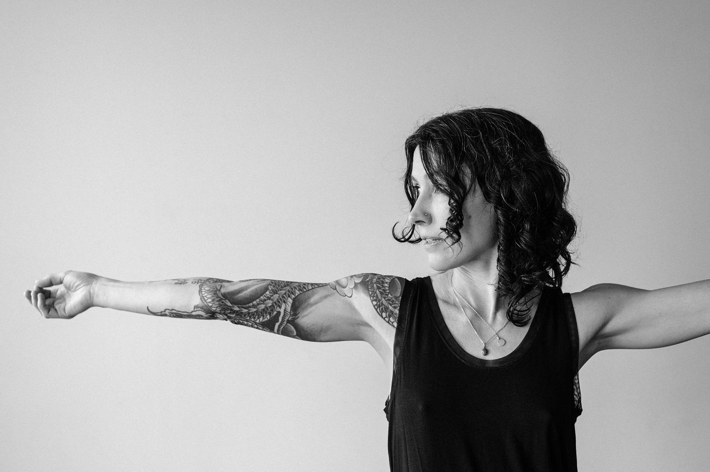 Dana Leigh Lyons in black and white with arms open and extended