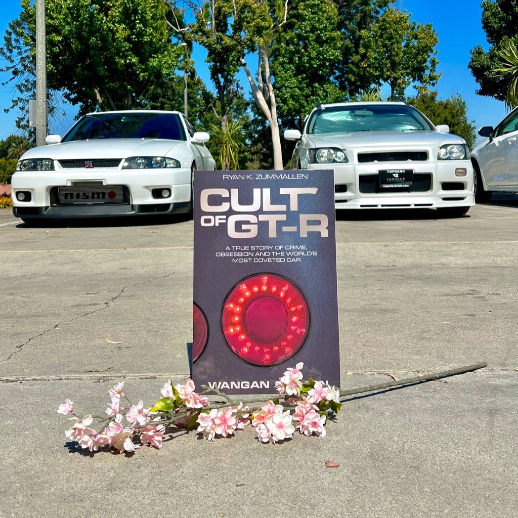 The cover of new car book 'Cult of GT-R' between an R33 Skyline GT-R Autech sedan and a Stagea 260RS station wagon. The cover of new car book 'Cult of GT-R' between an R33 Skyline GT-R Autech sedan and a Stagea 260RS station wagon.