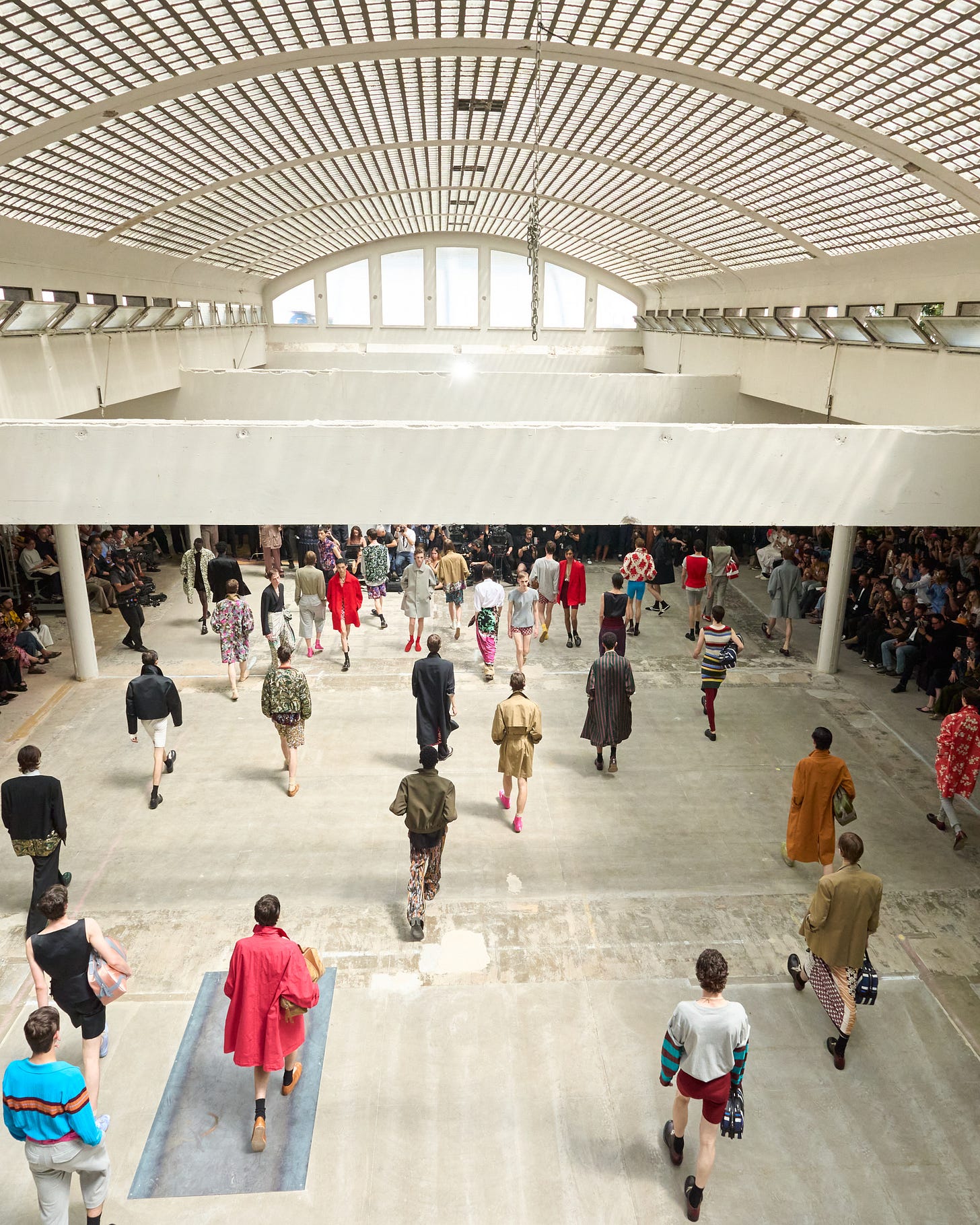 A rear shot taken at the end of Dries van Noten's final menswear show. We are looking down on the catwalk when all of the models came out together in a series of waves to take the final bow just before Mr. Dries van Noten joined them onstage to do the same.