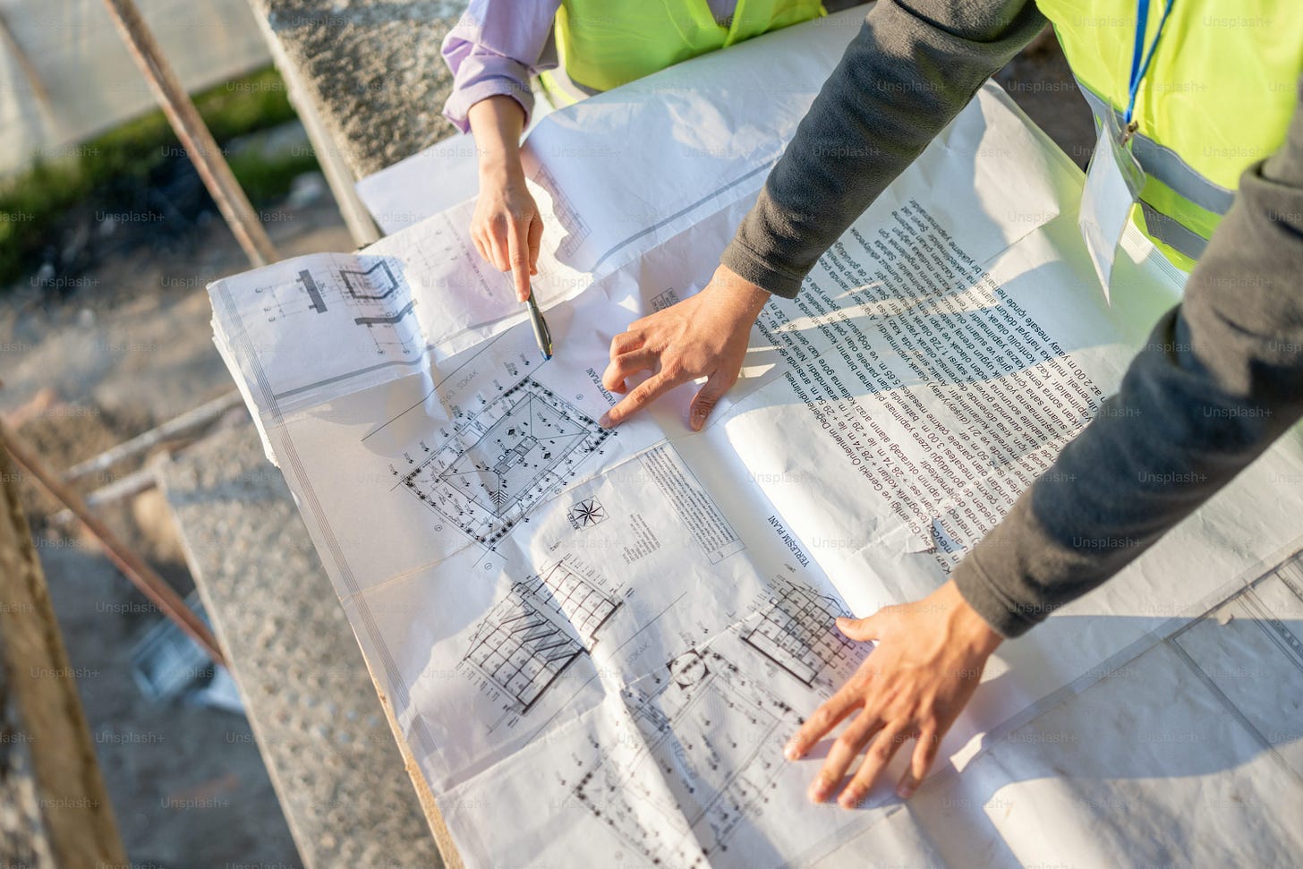 two people in safety vests working on a piece of paper