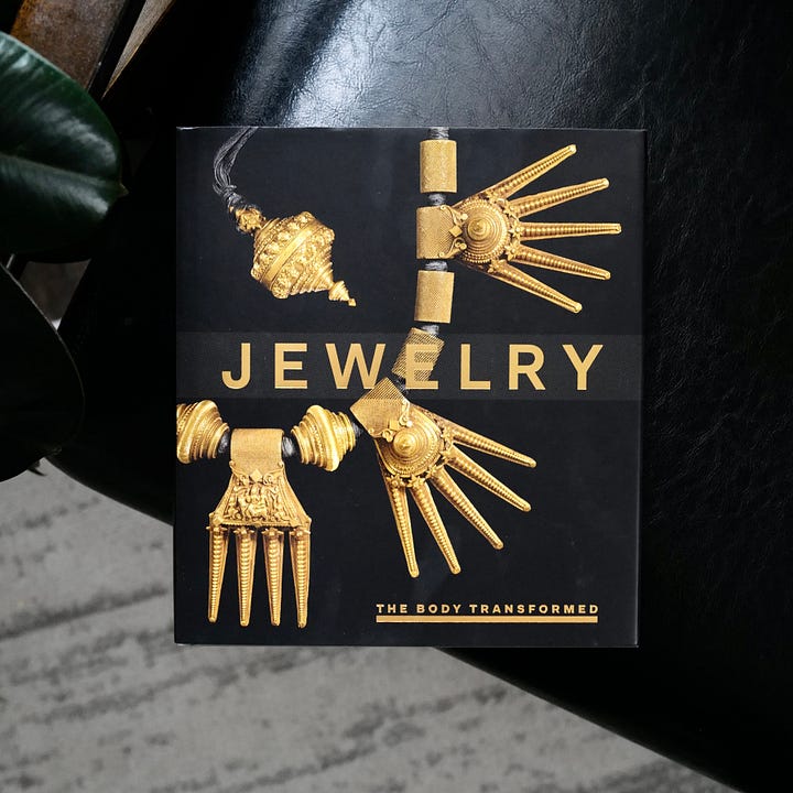 Two photos with cover and interior of the book on jewelry.