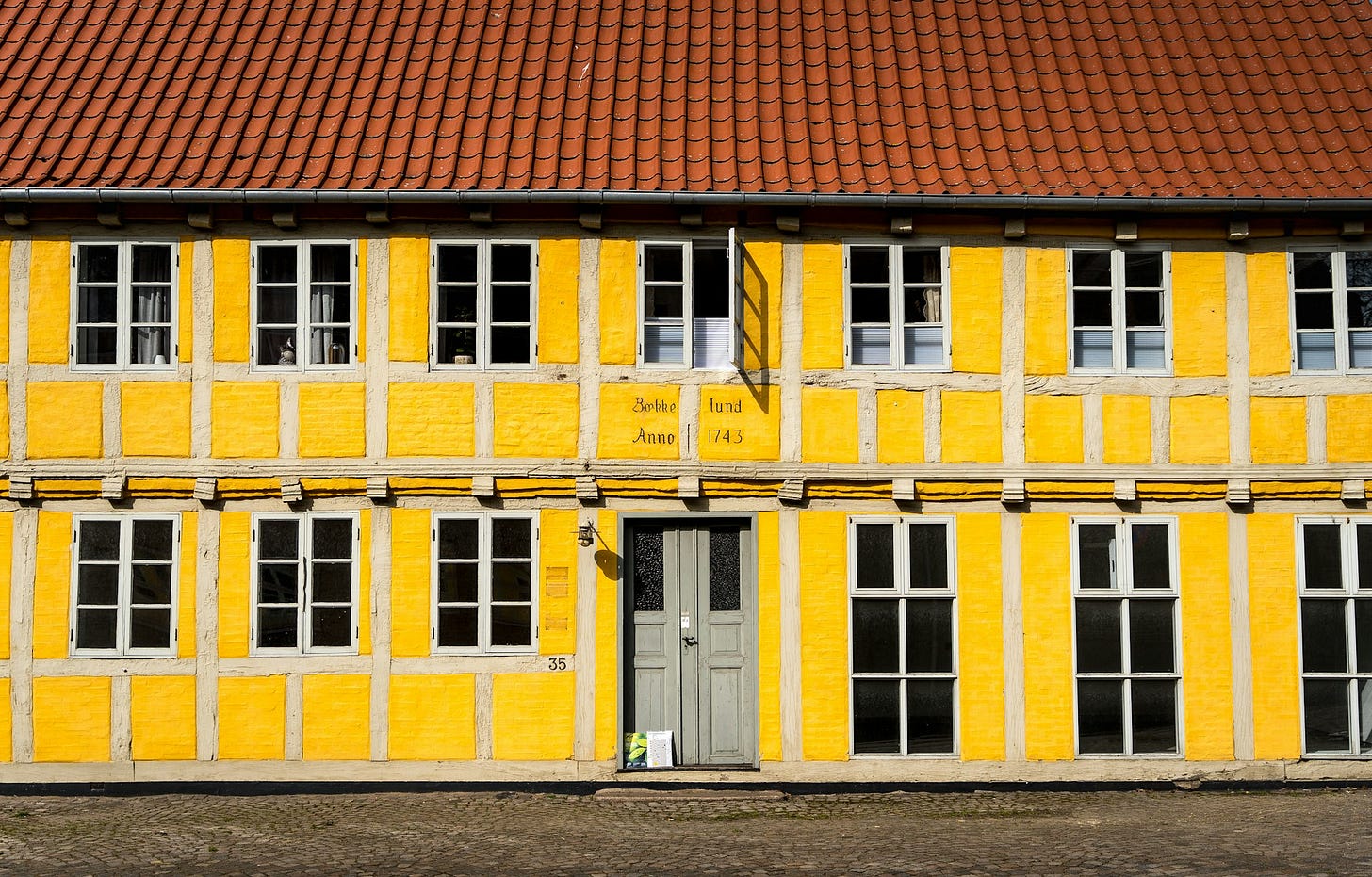A yellow half timbered house