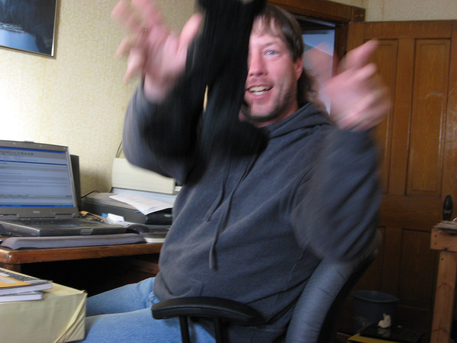 Farmer Rob tossing a stuffed animal at the camera holder