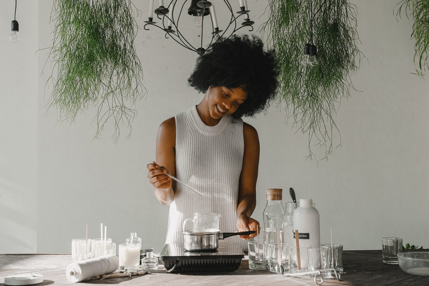 smiling woman making candles for workshop