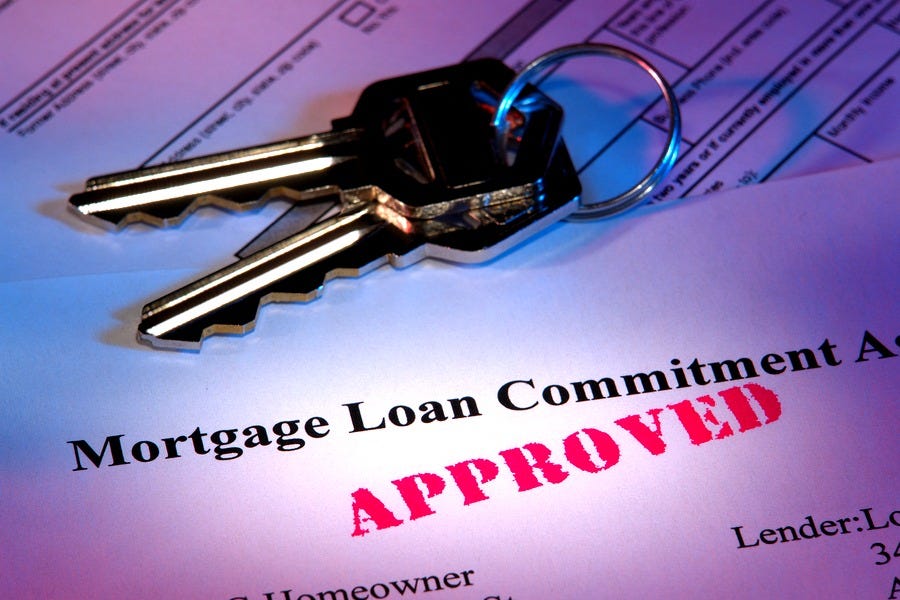 Image of an approved loan application with a set of two keys on top.