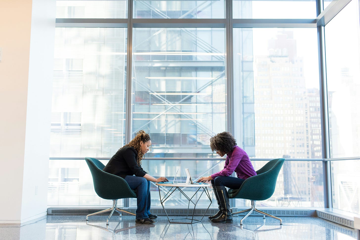 Two professionals in discussion across a table, illustrating perspective-taking, dialogue, and how different experiences shape interpretation, moral judgment, and understanding. Two professionals in discussion across a table, illustrating perspective-taking, dialogue, and how different experiences shape interpretation, moral judgment, and understanding.