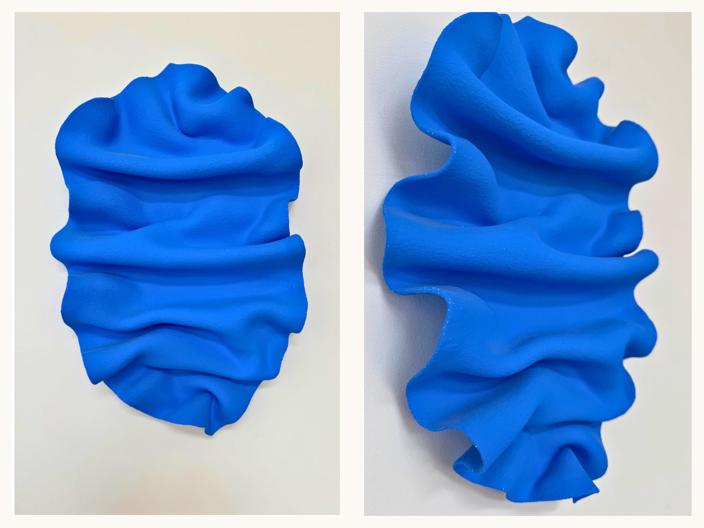 Front crop of a bright cobalt ceramic wall sculpture by Jessica Sellinger with soft, ruffled folds.