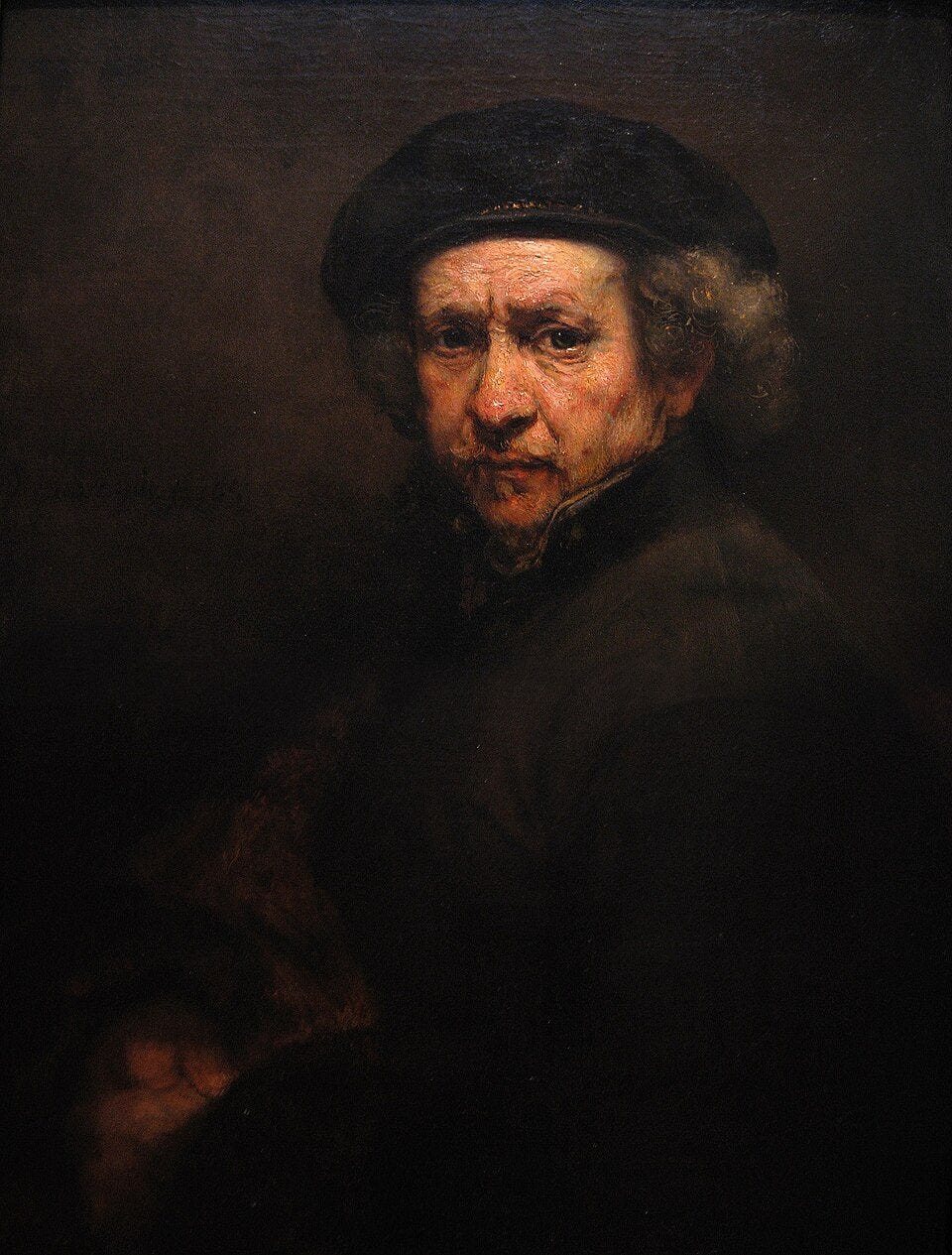 An older man in a dark beret and coat with a turned-up collar, his face lit against a dark brown background. An older man in a dark beret and coat with a turned-up collar, his face lit against a dark brown background.