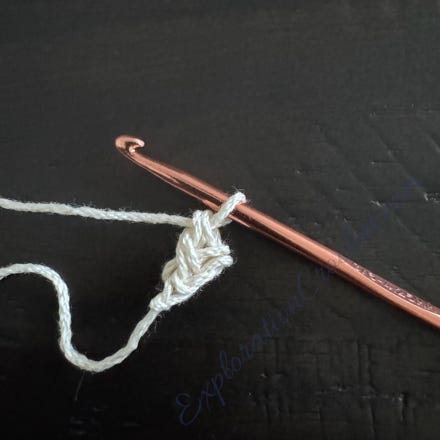 A crochet hook with a string

Description automatically generated