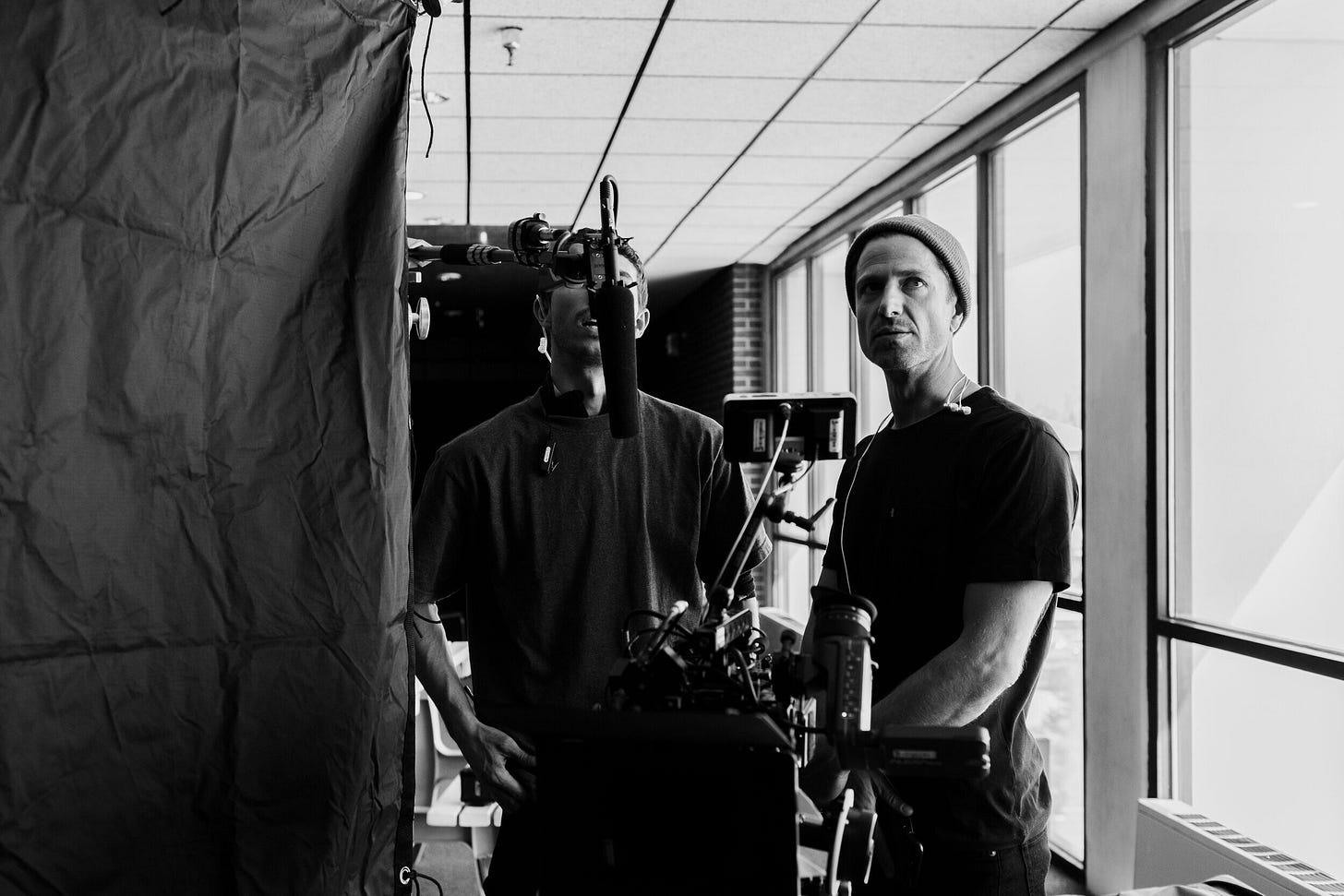 Dersu standing next to a camera looking visionary