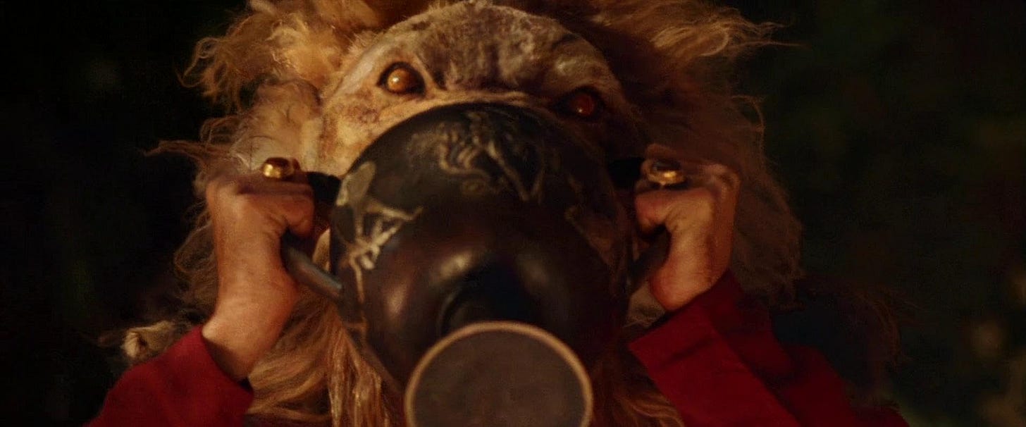 Alexander lion mask scene – Close-up of a character wearing an ornate lion head mask in Alexander Revisited: The Final Cut. Note: Still shown is promotional and not taken directly from the 4K UHD.