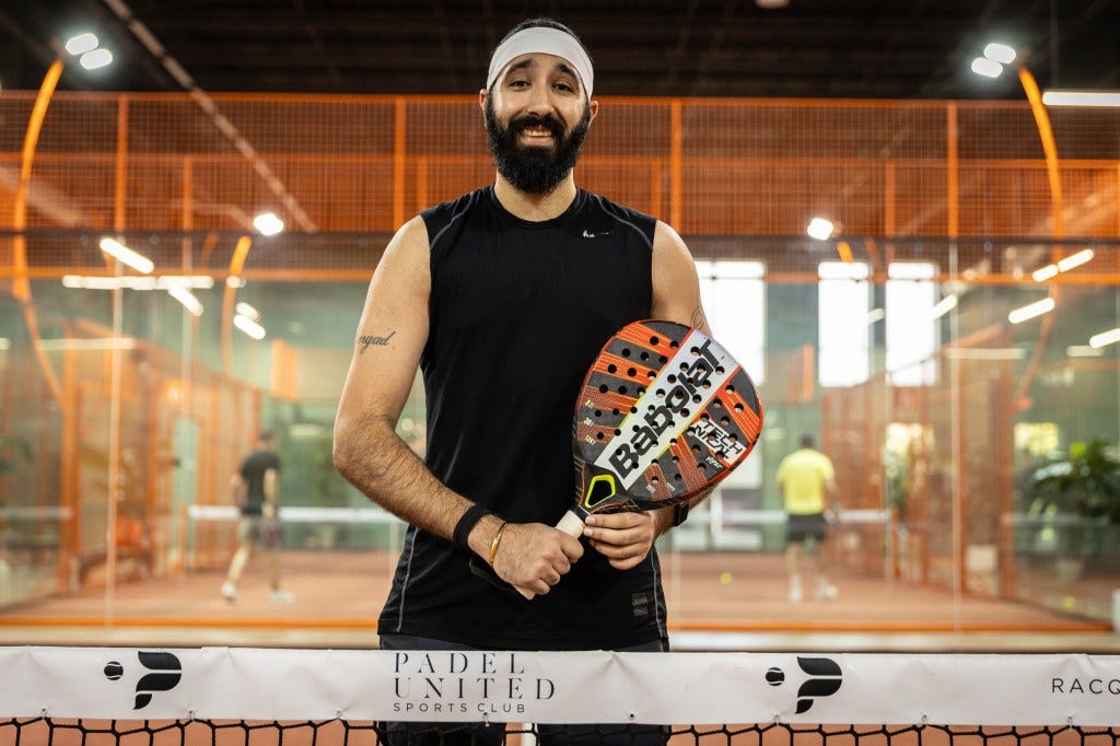 Jyot "Jay" Sawhney holding a padel racket 