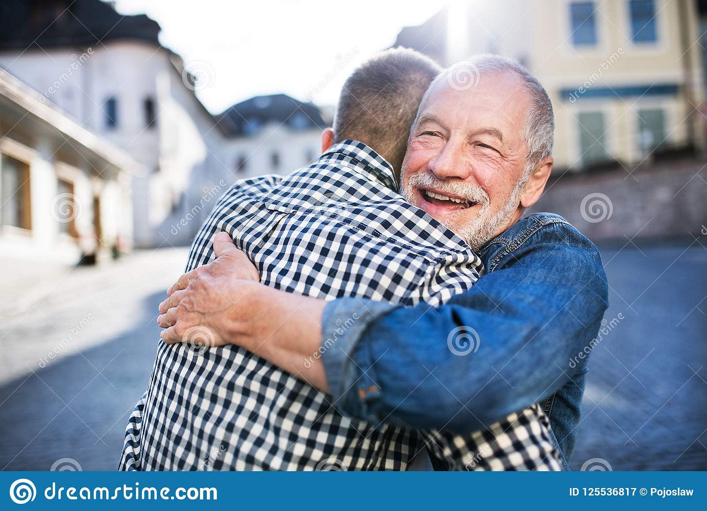 An Adult Hipster Son and His Senior Father in Town, Hugging. Stock ...