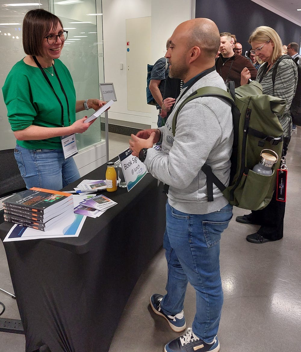 Susanne engaging with a reader at the book signing event.