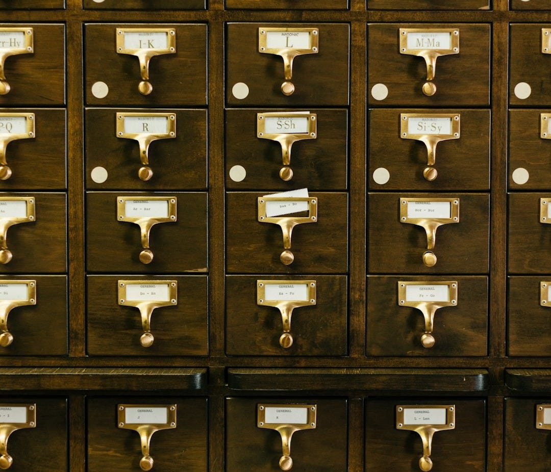 close-up photography of brown wooden card catalog close-up photography of brown wooden card catalog