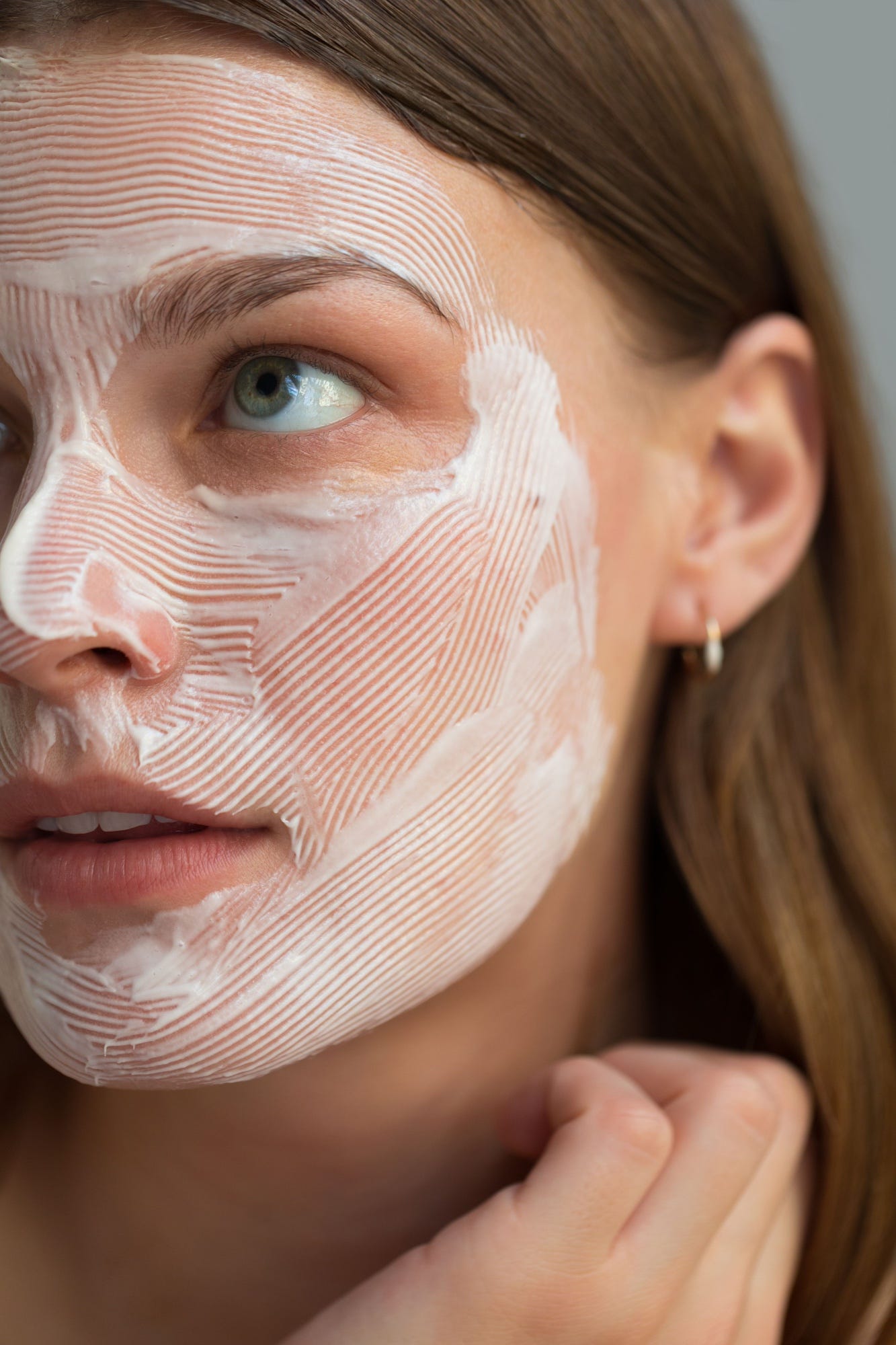 woman with lotion covering her face