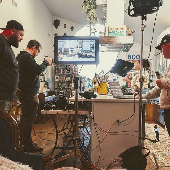 Aarti Sequeira's home kitchen, with Compassion international - dishes at the stove, film crew, food