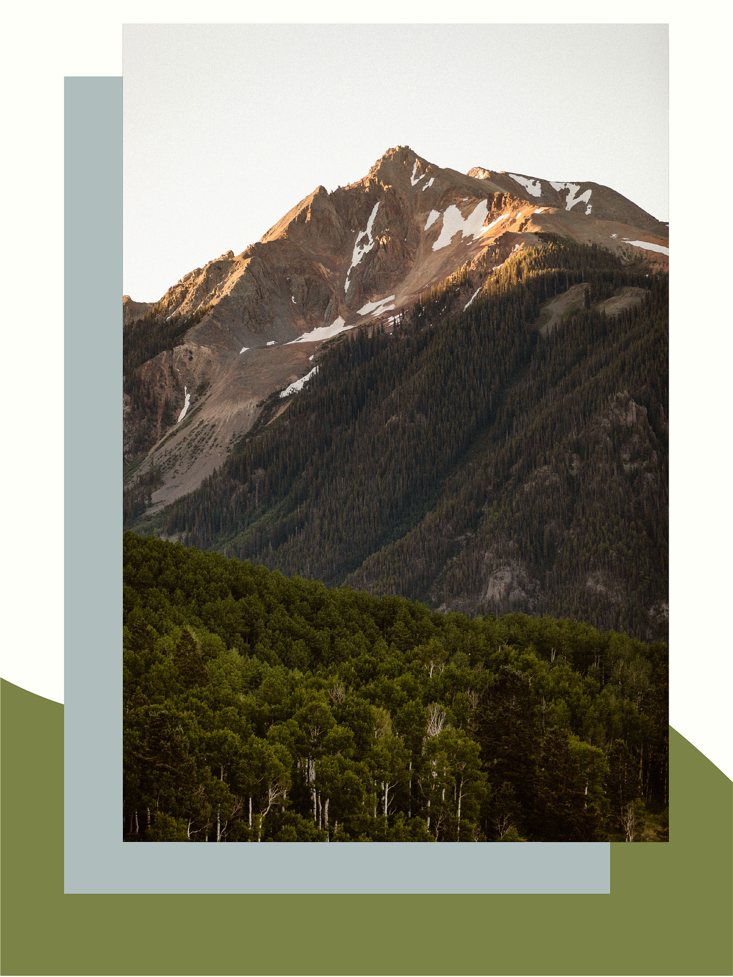 mountain tip basking in morning sunlight with trees covering the valley