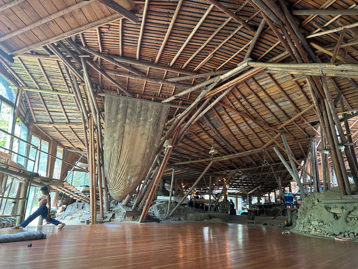 A cavernous wooden arched room with a big dancefloor
