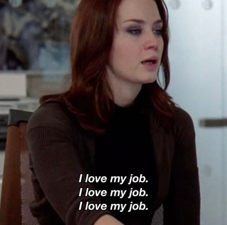 This may contain: a woman sitting at a table with a laptop in front of her and the words i love my job on it