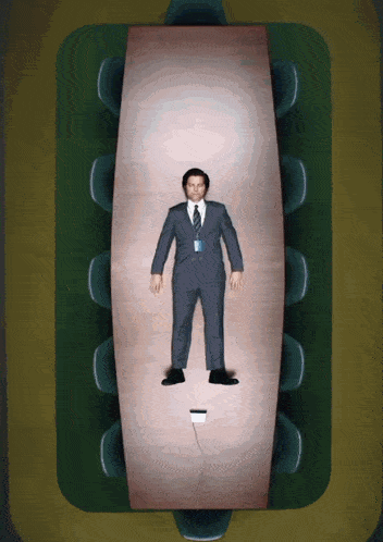 a man in a suit and tie is laying on a table