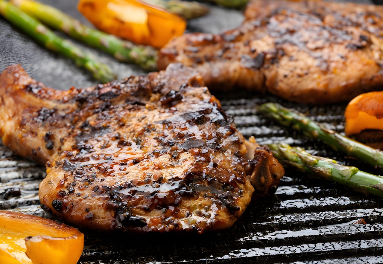 Close-up of meat and vegetables cooking on a grill Close-up of meat and vegetables cooking on a grill