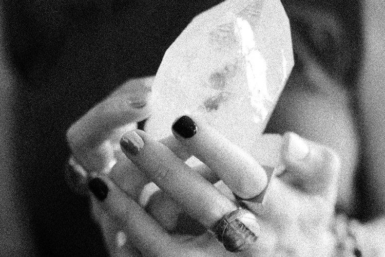 an image of hands holding a crystal an image of hands holding a crystal