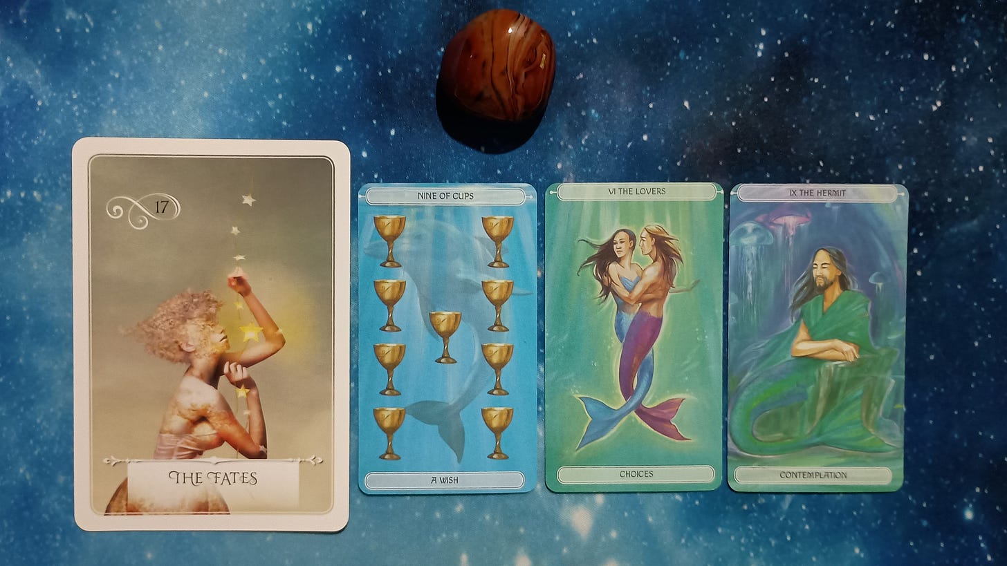 New Moon Pick-a-Card Tarot Reading for May 2025, pile 4 - Silk Agate (red and brown) stone and 4 cards on a starry blue background