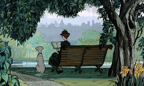 101 Dalmations gif of woman reading on bench in park next to dog