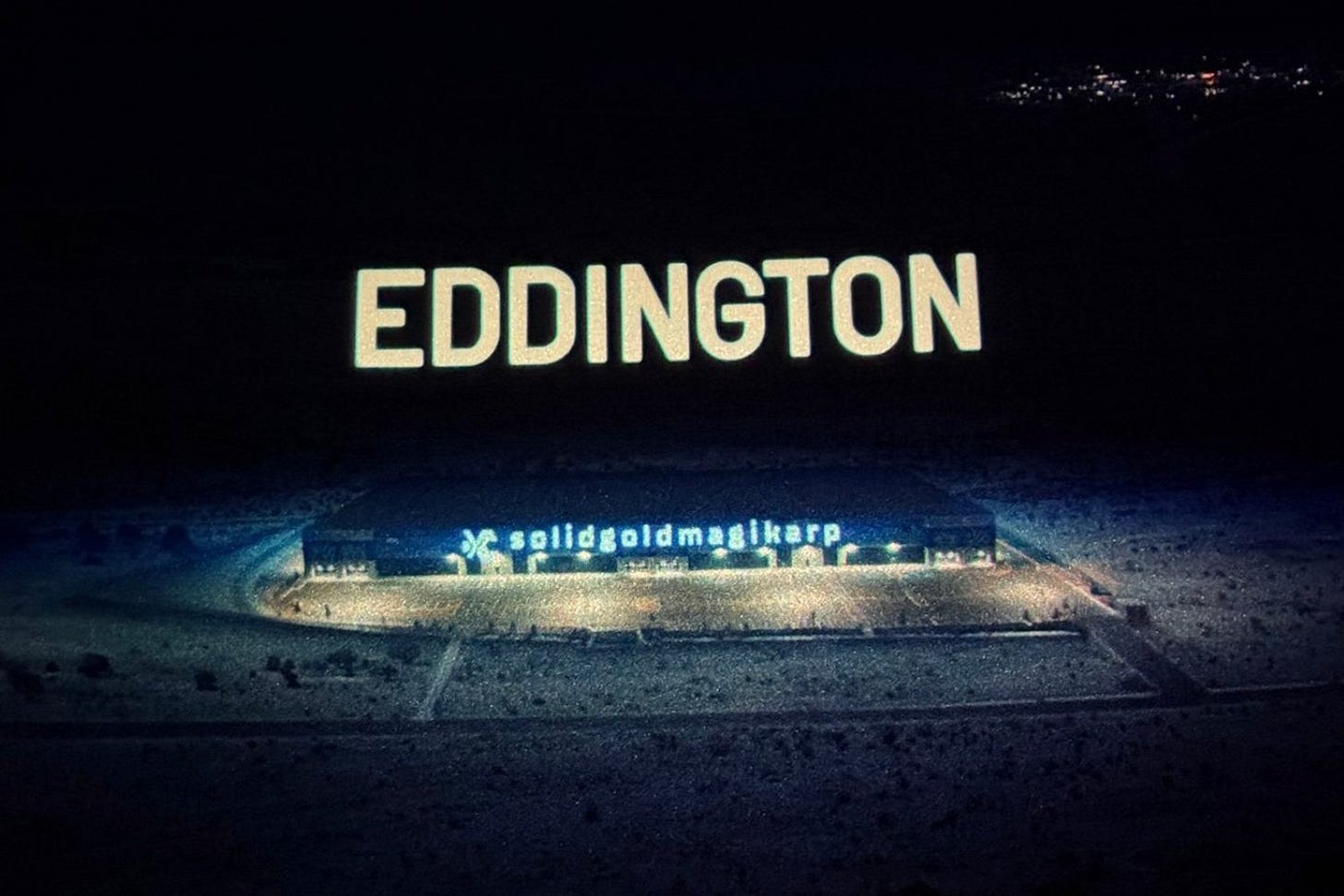 Screenshot from Eddington showing a large building with a sign that reads "Solidgoldmagikarp."