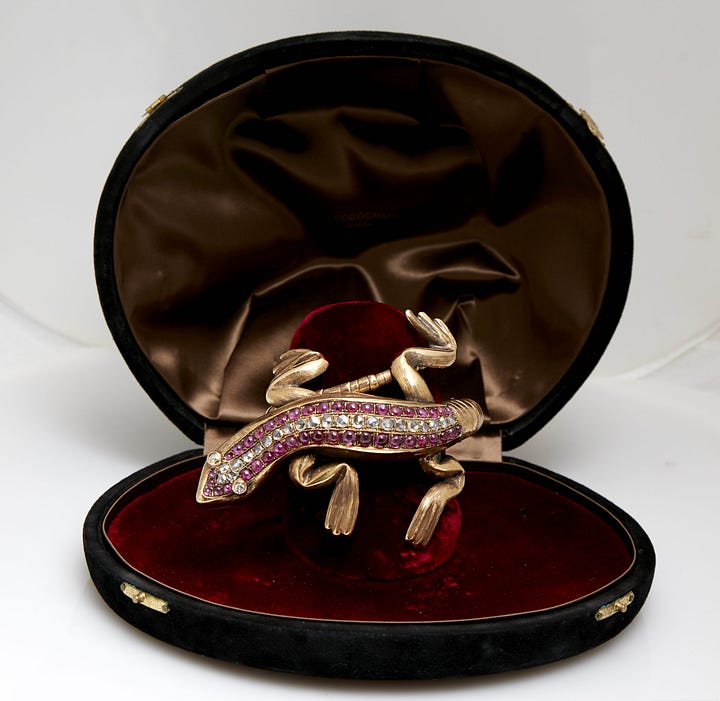 Gold and ruby salamander bracelet. Gold and enamel skull earrings