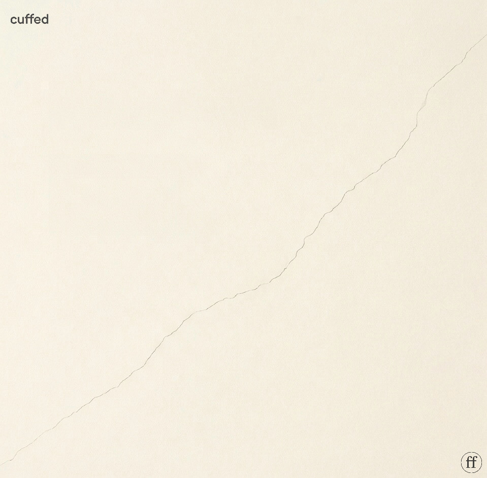 cream background with a single hairline diagonal crack running corner to corner. cuffed logo top-left in small black lowercase serif. fused ff logo bottom-right in black. the crack is thin, irregular, and barely visible — suggesting early fracture rather than collapse. mood: stillness, structural tension, masculine restraint. seo: consistency in relationships, trust issues, emotional unavailability, relationship psychology, cuffed musing 94.
