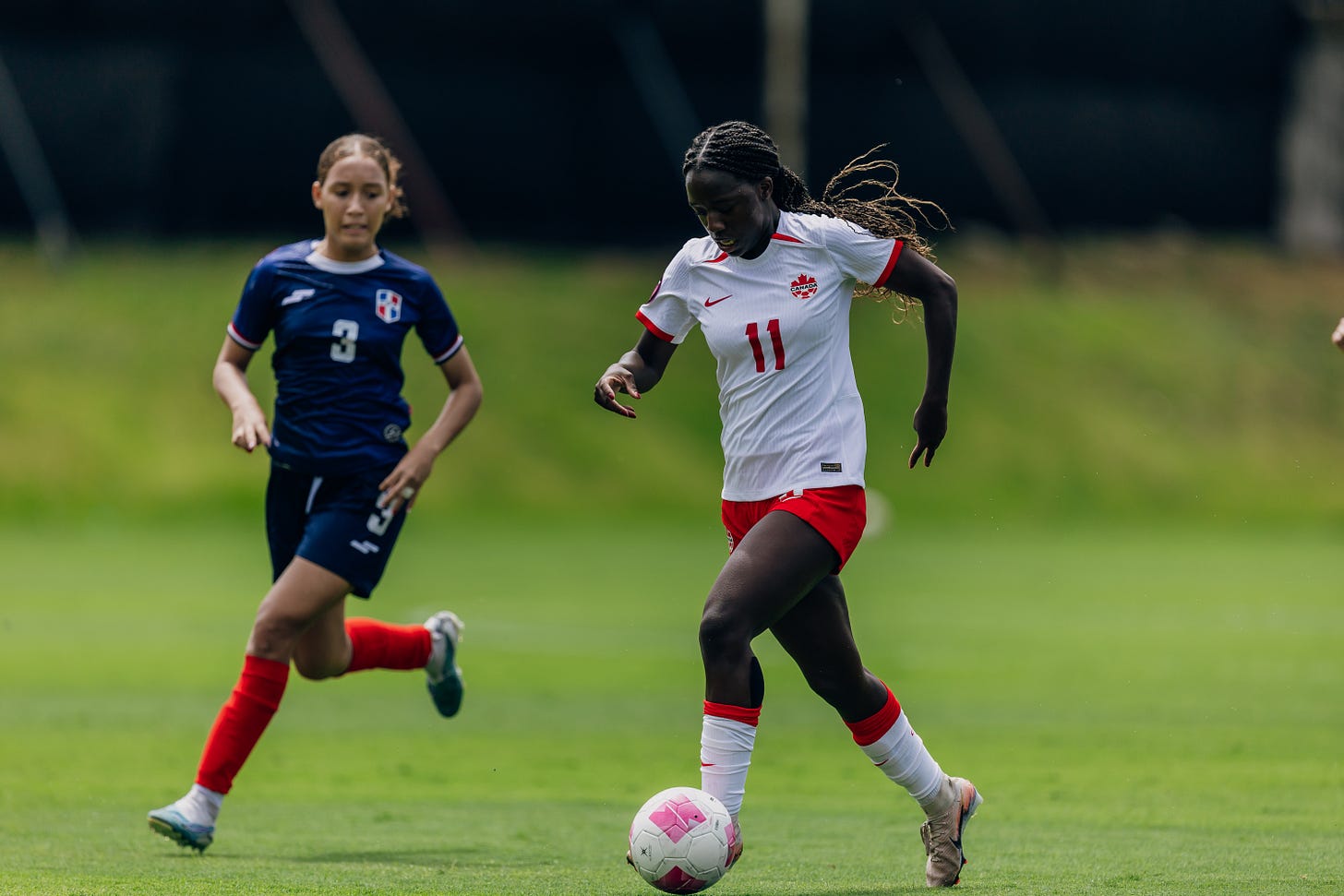 Forward Asekomhe on the ball driving at the opponent's goal
