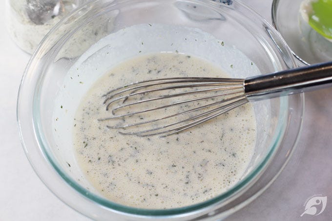 Homestyle Ranch Dressing & Dip Mix ingredients whisked together in a bowl. Homestyle Ranch Dressing & Dip Mix ingredients whisked together in a bowl.