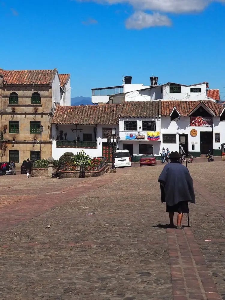 An elderly lady crossing the main square An elderly lady crossing the main square