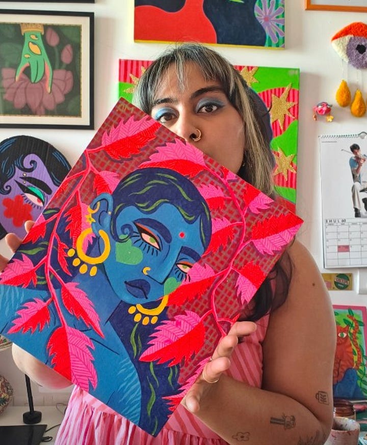First photo: gold star earrings with wrap around chains that fasten in the clasp.  Second photo: artist Maanya Dhar with their painting of a woman in red leaves. 