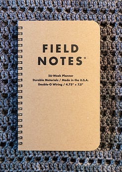 The cover of a Field Notes planner, which is plain brown with Field Notes in black text The cover of a Field Notes planner, which is plain brown with Field Notes in black text