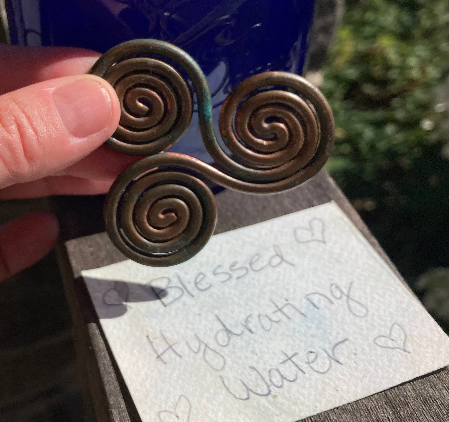 picture of a copper resting ring and a blessing beneath it