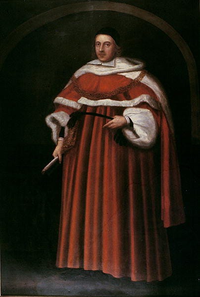 A Portrait of Matthew Hale. He stands in a full-length brown judge's robe with a black cap on his head. In his right hand, he holds a paintbrush. A Portrait of Matthew Hale. He stands in a full-length brown judge's robe with a black cap on his head. In his right hand, he holds a paintbrush.