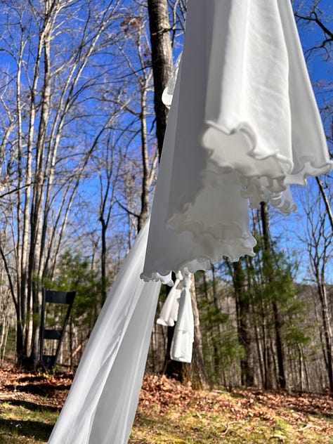White laundry on a laundry line blows in the wind