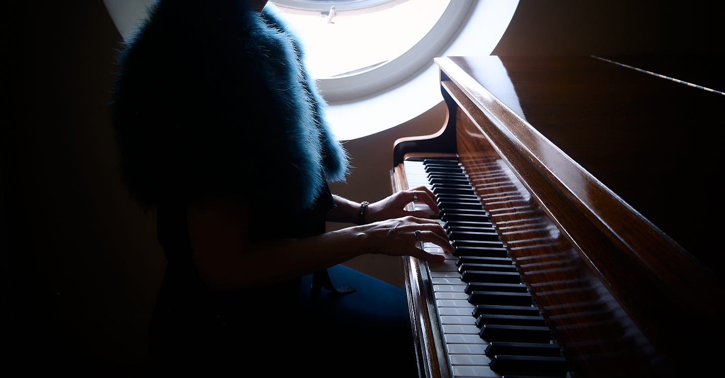 Danielle Styles playing a grand piano. Danielle Styles playing a grand piano.