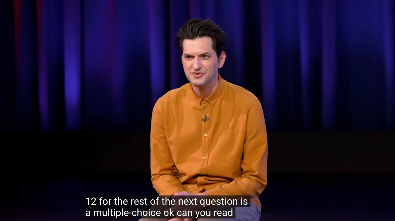 ben schwartz makes a "what the fuck" face to the camera as the closed caption reads "ok can you read"