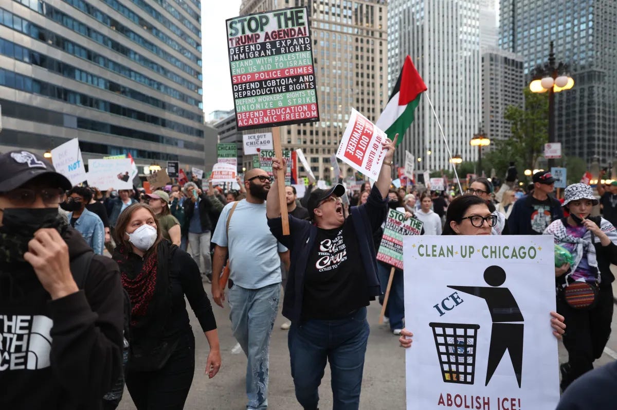 Protesters flip off Trump Tower during a protest against immigration raids in Chicago 