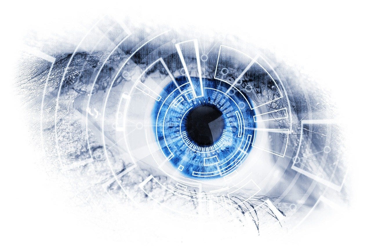 A bright blue eye overlaid with technological-looking lines and symbols.