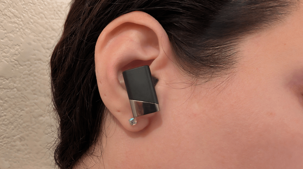 Earbuds in woman's ear for Status Pro X review Earbuds in woman's ear for Status Pro X review