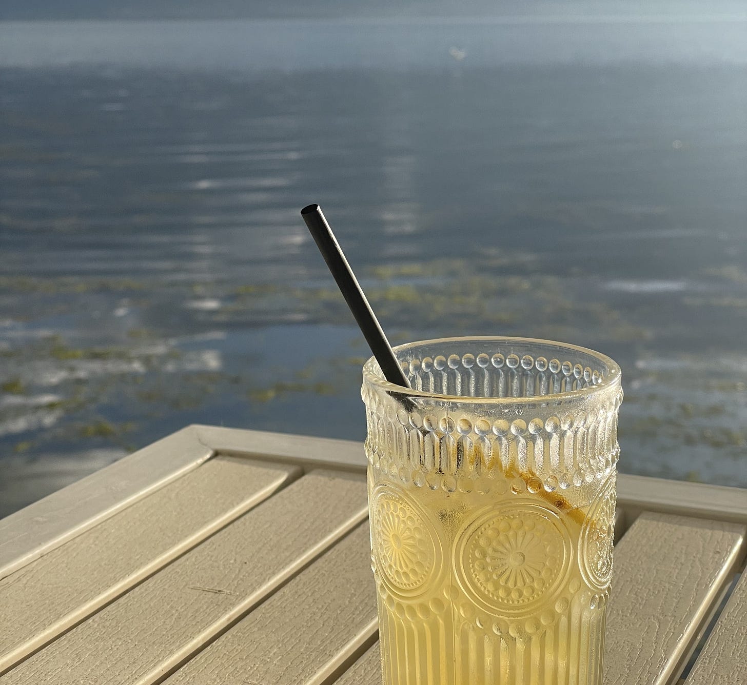 Mocktail on a table with lake in background